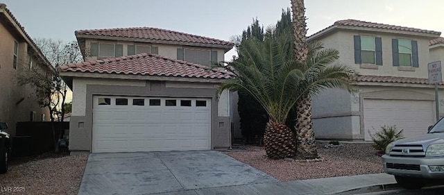 mediterranean / spanish-style house with a garage