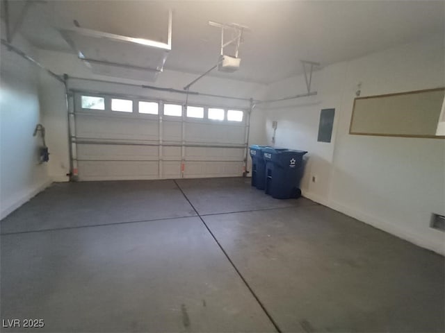 garage featuring electric panel and a garage door opener