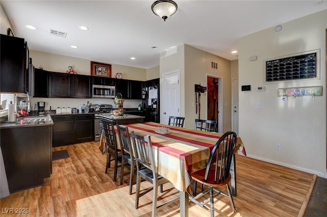 kitchen featuring sink, stainless steel appliances, light hardwood / wood-style flooring, and dark brown cabinets