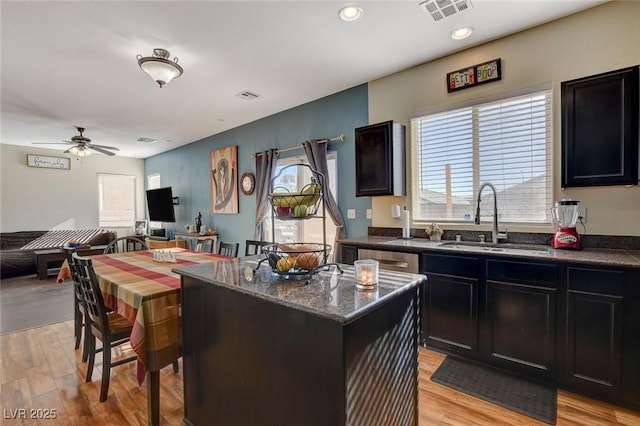 kitchen featuring a center island, ceiling fan, light hardwood / wood-style flooring, and sink