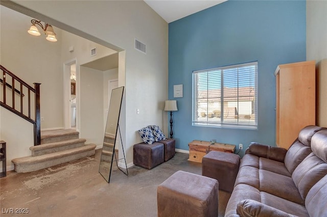 living room featuring a high ceiling and a chandelier