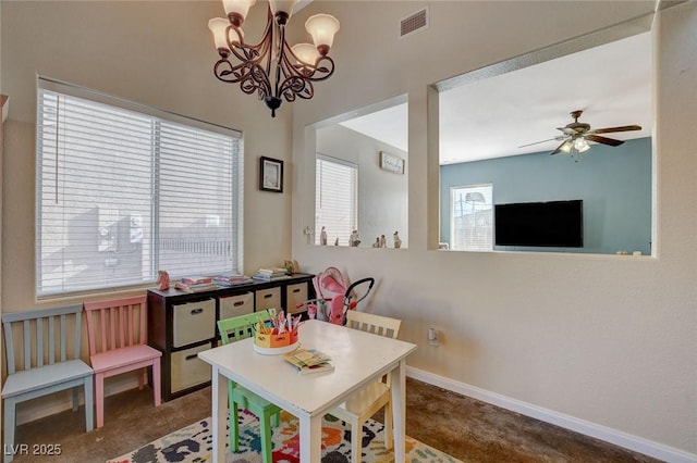 rec room featuring ceiling fan with notable chandelier