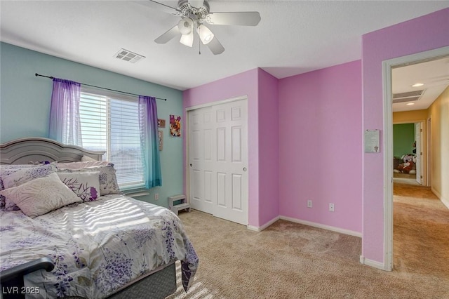 bedroom featuring a closet, ceiling fan, and light carpet