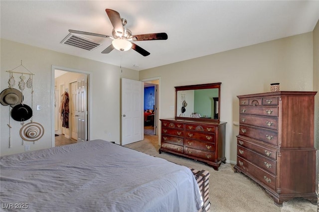 bedroom with ceiling fan and light colored carpet