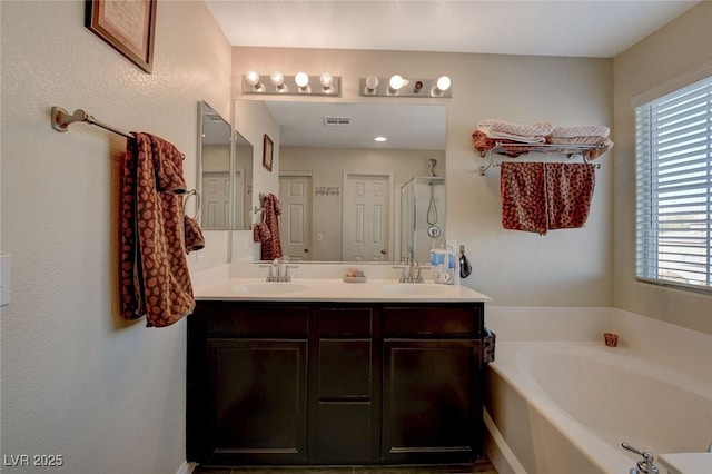 bathroom featuring independent shower and bath and vanity