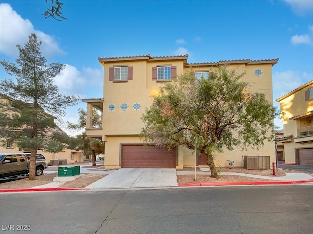 mediterranean / spanish-style home with a garage