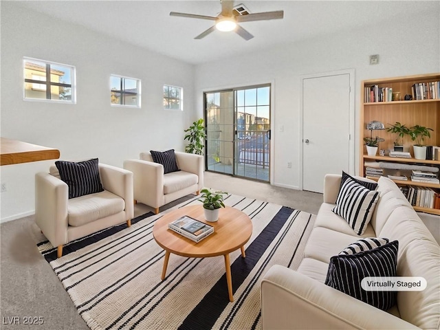 carpeted living room featuring ceiling fan and a healthy amount of sunlight