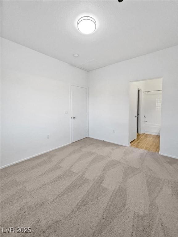 unfurnished room with light colored carpet