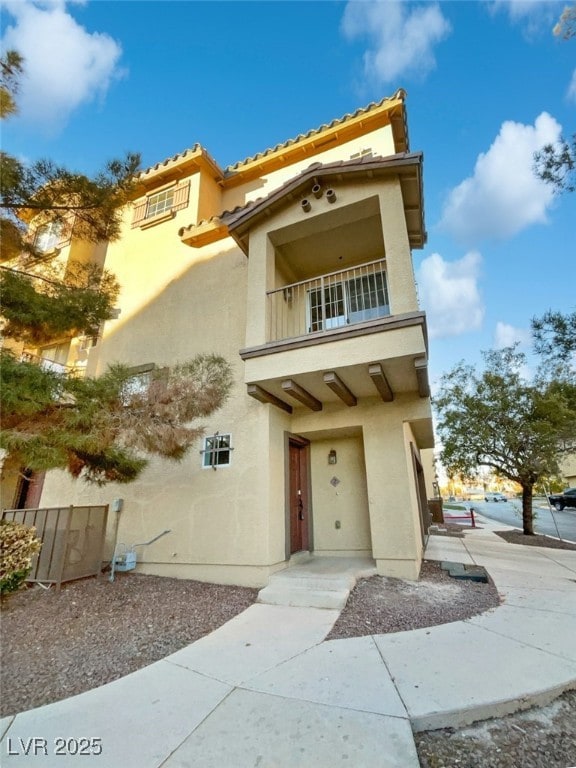 mediterranean / spanish house featuring a balcony