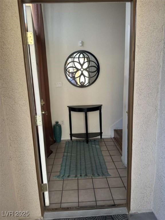 corridor featuring light tile patterned floors