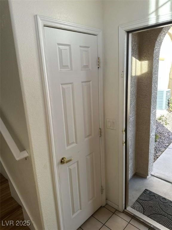 doorway with light tile patterned floors