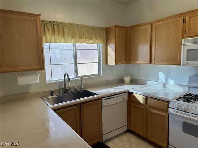 kitchen featuring sink, white appliances, and light tile patterned floors