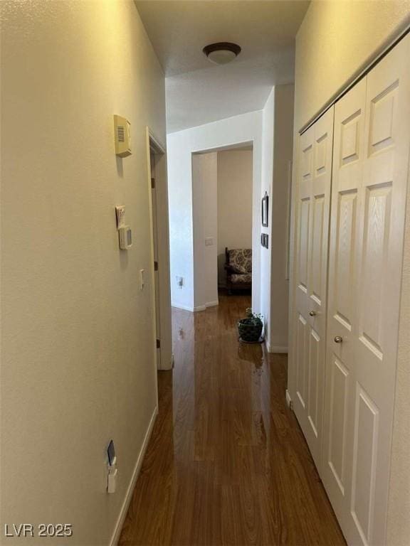 hallway featuring dark hardwood / wood-style flooring