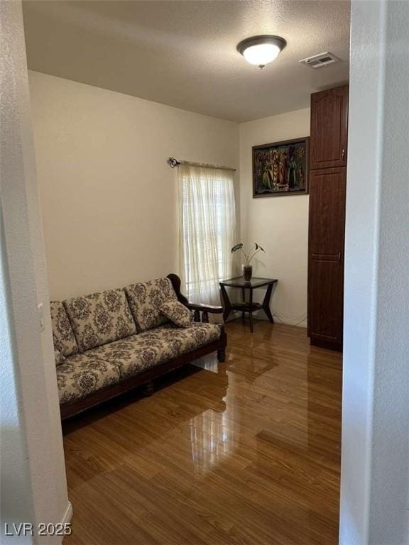 living room featuring a textured ceiling and hardwood / wood-style floors