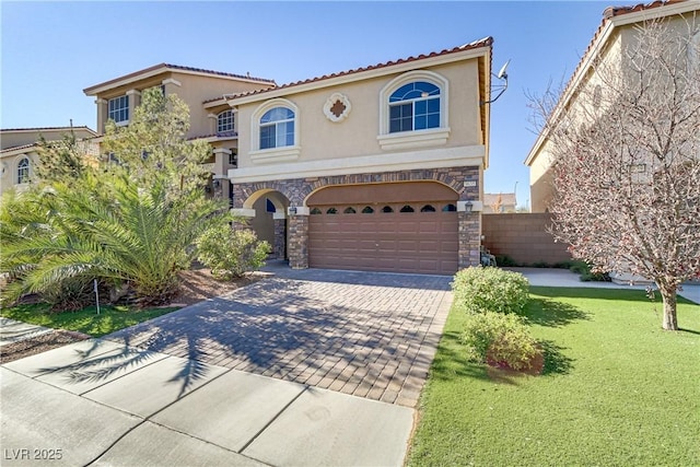 mediterranean / spanish house with a front lawn and a garage