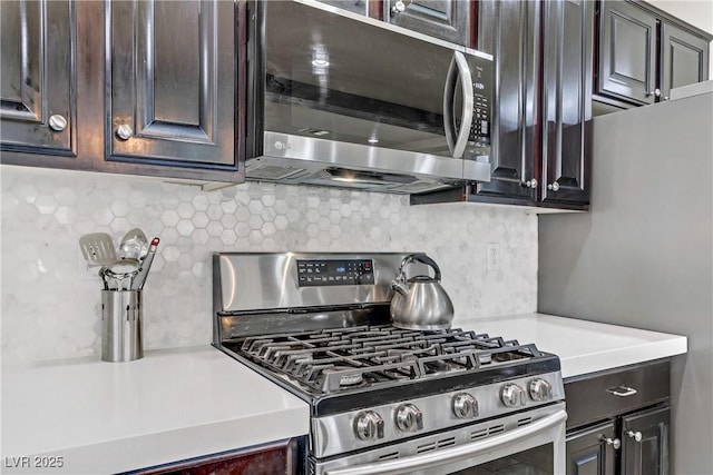 kitchen featuring stainless steel appliances, dark brown cabinets, and tasteful backsplash