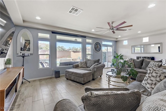 living room with light wood-type flooring and ceiling fan