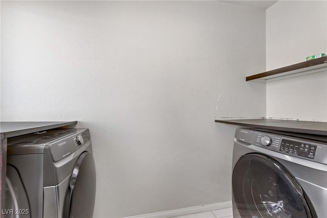 clothes washing area featuring light tile patterned flooring and separate washer and dryer