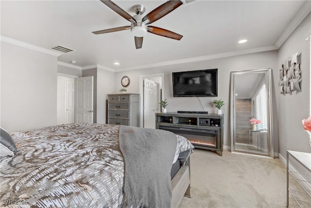 bedroom featuring ceiling fan, ornamental molding, and light colored carpet