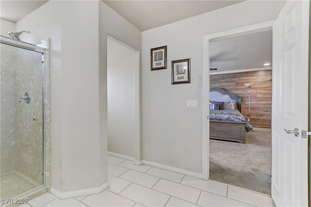 bathroom featuring a shower with door, wooden walls, and tile patterned floors