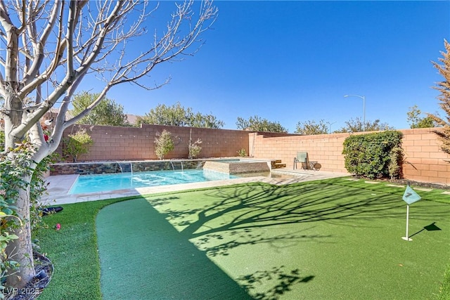 view of pool featuring pool water feature and an in ground hot tub