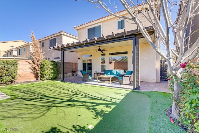 rear view of house with ceiling fan, a patio, and an outdoor living space