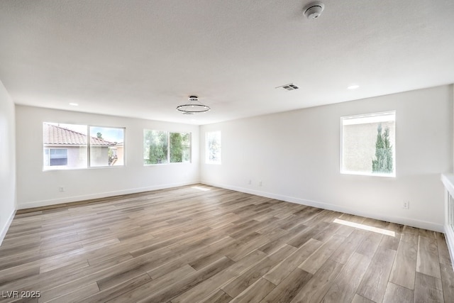 spare room featuring light hardwood / wood-style floors