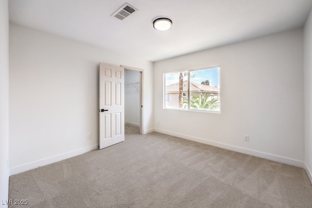 spare room featuring light colored carpet