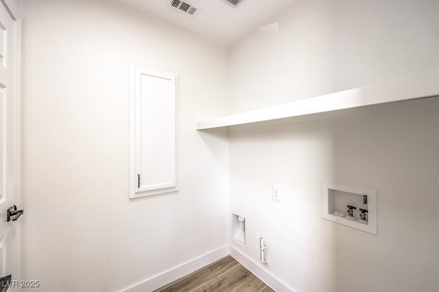 clothes washing area with washer hookup, light wood-type flooring, hookup for a gas dryer, and electric dryer hookup