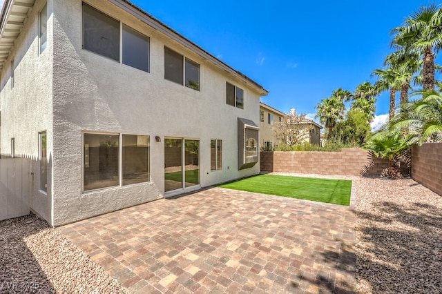 back of property with a patio