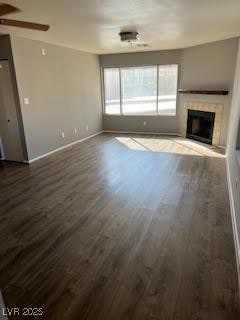 unfurnished living room with ceiling fan and dark hardwood / wood-style floors