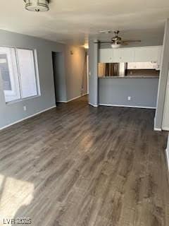 unfurnished living room featuring dark hardwood / wood-style flooring and ceiling fan