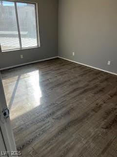 unfurnished room with dark hardwood / wood-style flooring