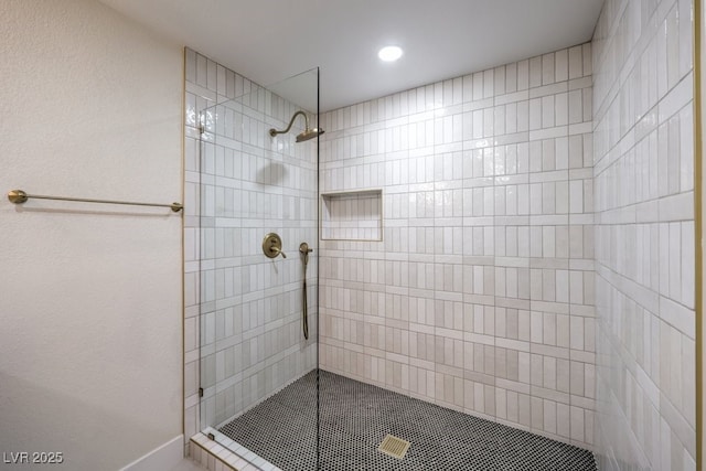 bathroom with a tile shower