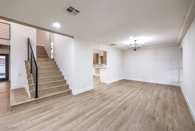 interior space with ornamental molding, light hardwood / wood-style flooring, and a chandelier