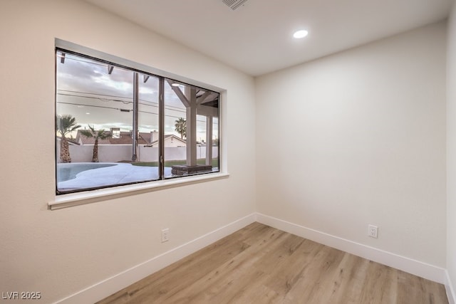 spare room featuring hardwood / wood-style floors