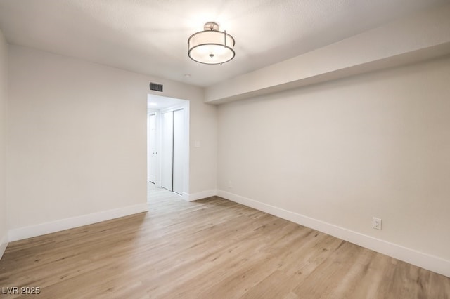 spare room with light wood-type flooring