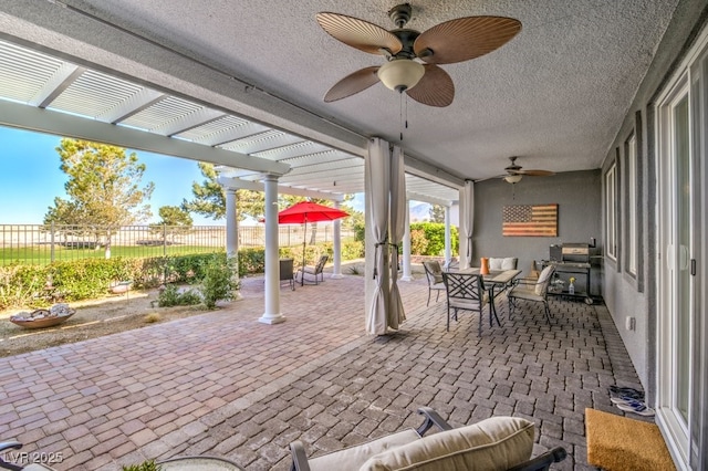 view of patio / terrace featuring ceiling fan and a pergola