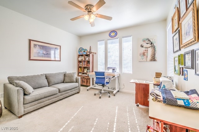 office space featuring ceiling fan and light carpet