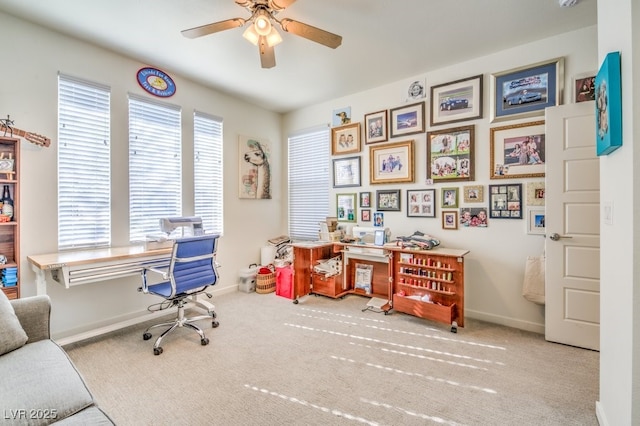 office space with ceiling fan and light colored carpet