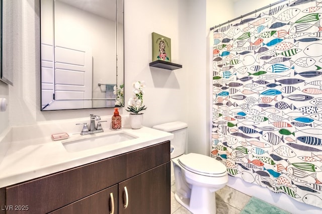 bathroom featuring toilet, vanity, and tile patterned floors