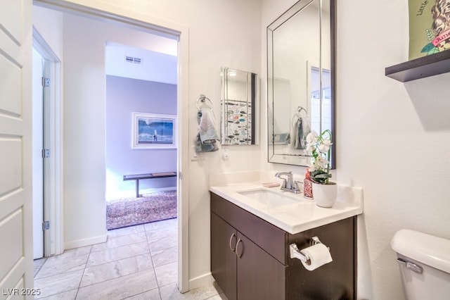 bathroom with toilet and vanity