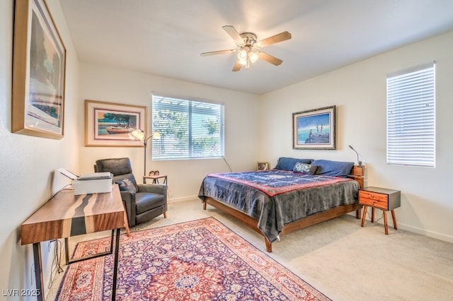 bedroom featuring light colored carpet and ceiling fan