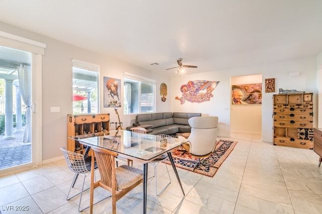 living room featuring ceiling fan and light tile patterned floors