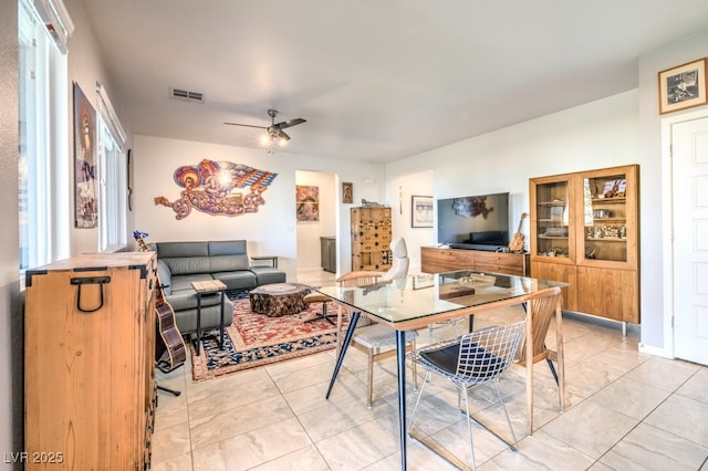 dining area with light tile patterned flooring and ceiling fan