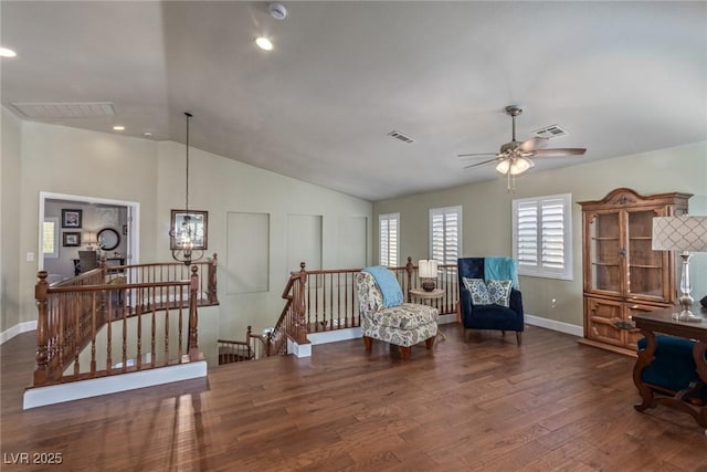 sitting room featuring ceiling fan, dark wood-type flooring, and vaulted ceiling