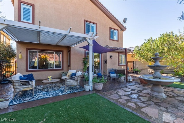 rear view of property featuring a patio area, a pergola, and an outdoor living space