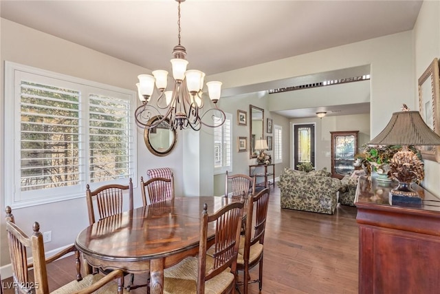 dining area with a chandelier and dark hardwood / wood-style flooring