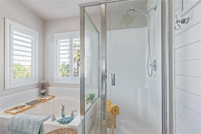 bathroom featuring independent shower and bath