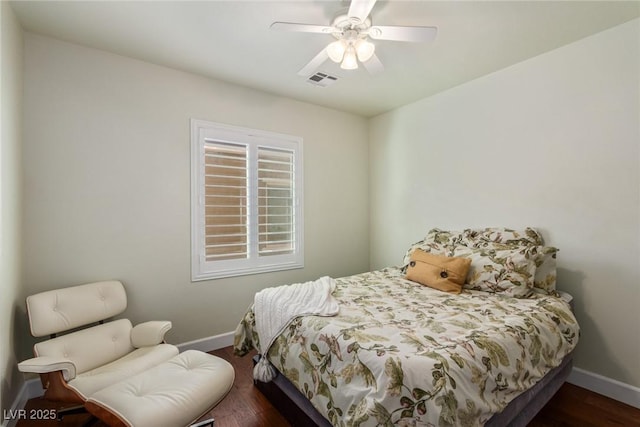 bedroom with ceiling fan and dark hardwood / wood-style floors